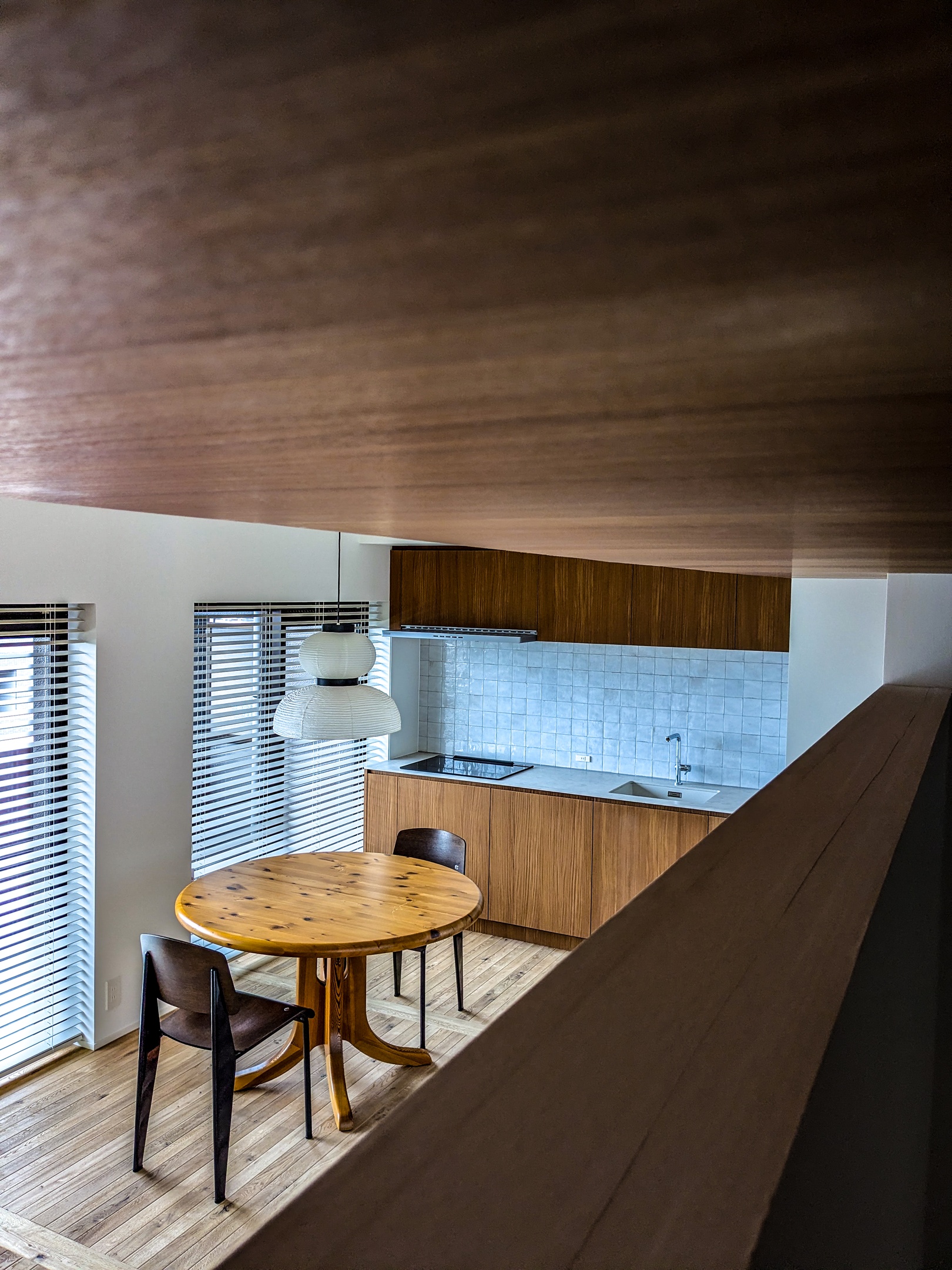 Corridor view of the living room. &Tradition light , Jean Prouvé Chair and Daumiller Table. Natural light from the window. Wood floor korean style and brand new kitchen with a retro style.
